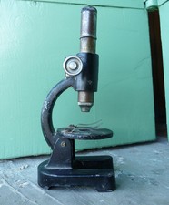 Antico microscopio giocattolo in latta e alluminio