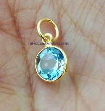 Charm in oro topazio blu