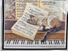 Sleeping Cat on Piano Paper