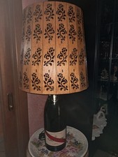 LUME ARTIGIANALE CON BOTTIGLIA DI CHAMPAGNE E PARALUME IN LEGNO INTAGLIATO.
