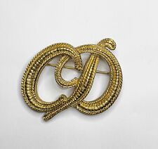 CHRISTIAN DIOR. Gold-plated "CD" brooch. 80s. con piccolo difetto (vedi foto)