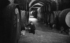 Man posing beside a barrel at