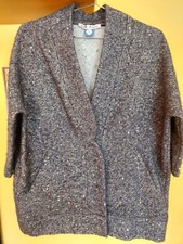 Giacca melange grigia, in tessuto tipo maglia con paillette, realizzata da una s