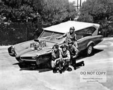 THE MONKEES STAND NEXT TO "THE