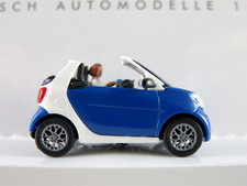 Busch 50779 Smart Fortwo Cabrio (2016) con conducente e bambino 1:87/H0 NUOVO/CONFEZIONE ORIGINALE