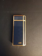Accendino  Must de CARTIER laccato blu scuro , profili placcati oro.