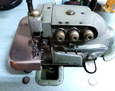 Macchina da cucire taglia e cuci elettrica  Rimoldi con mobile e supporto fili