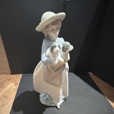 LLADRO nao girl holding 2 dogs