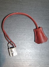 HERMÈS lucchetto in argento con gancio in pelle bordeaux