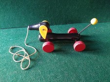 BRIO Cane Bassotto in legno dipinto e plastica con corda Traino