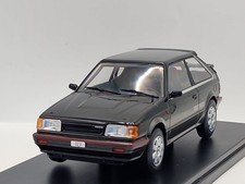Modellino auto Mazda 323 4WD Turbo 1989 nero grigio 1:24 whitebox