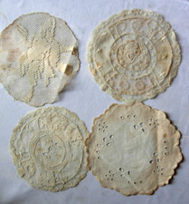 Four lace doilies one with a