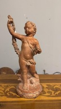 Antica scultura putto festante