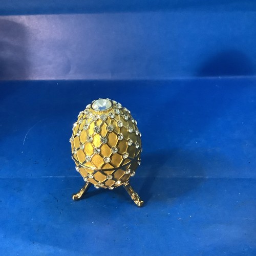 Jeweled gold faberge egg is - jeweled,